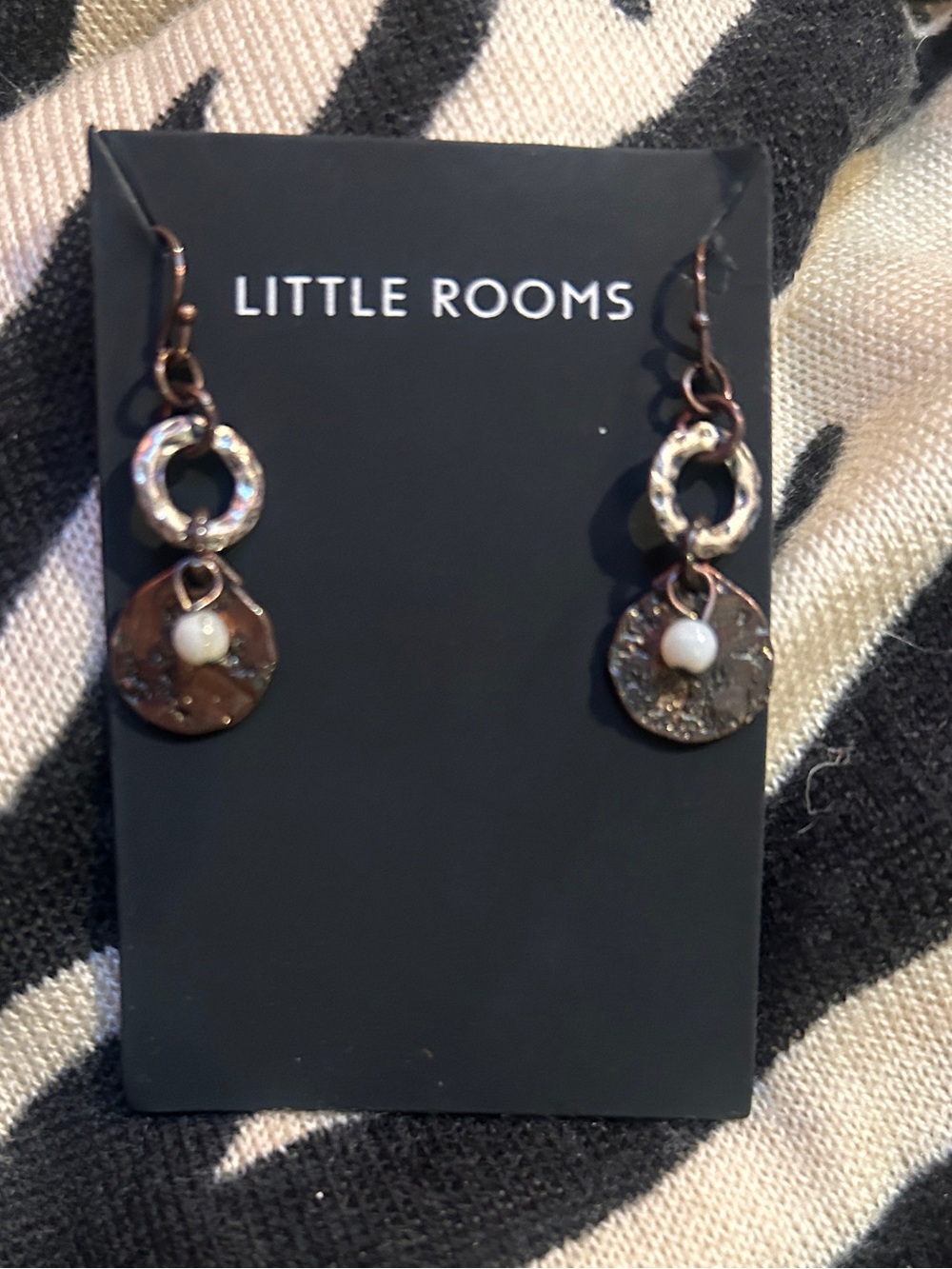 Hammered Circle Drop Earrings in Copper with white bead accent.